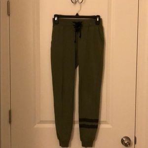 dark green sweatpants with two matte black stripes